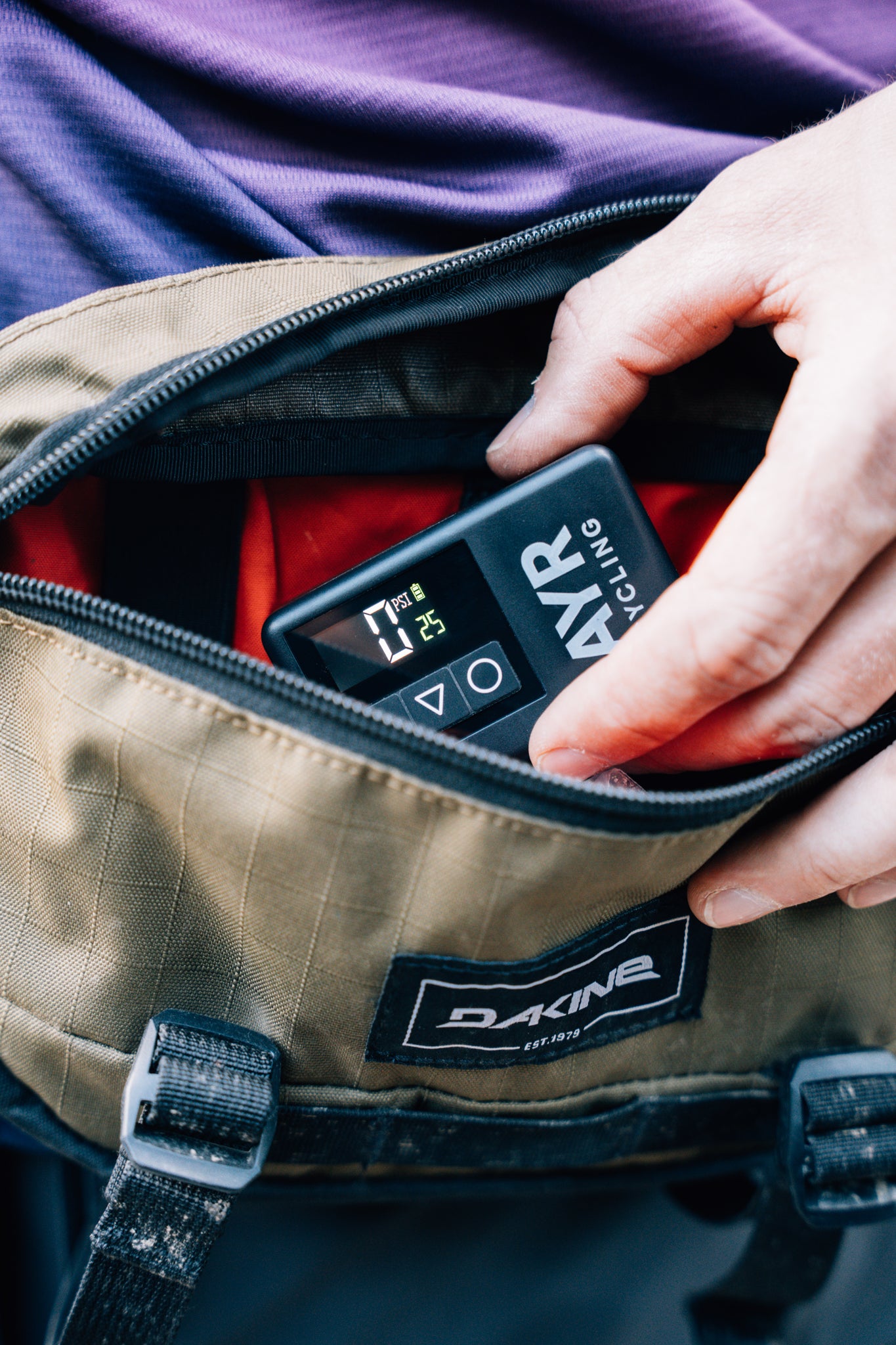 AYR Cycling electric pump stored in a rider’s bike bag, showing compact size and digital display