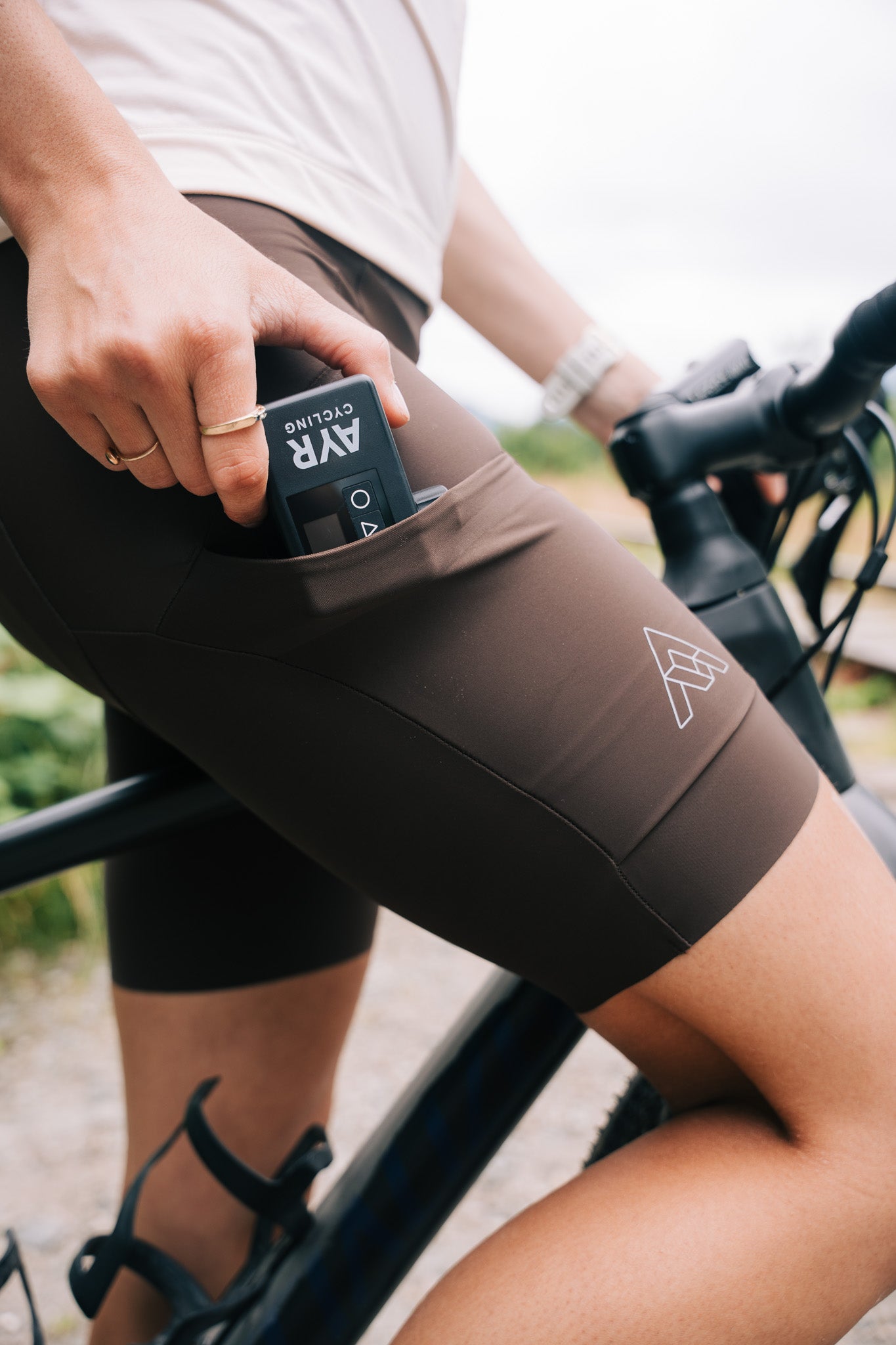 AYR Cycling E-Pump fitting into a cyclist’s pocket, demonstrating compact and portable design for rides.