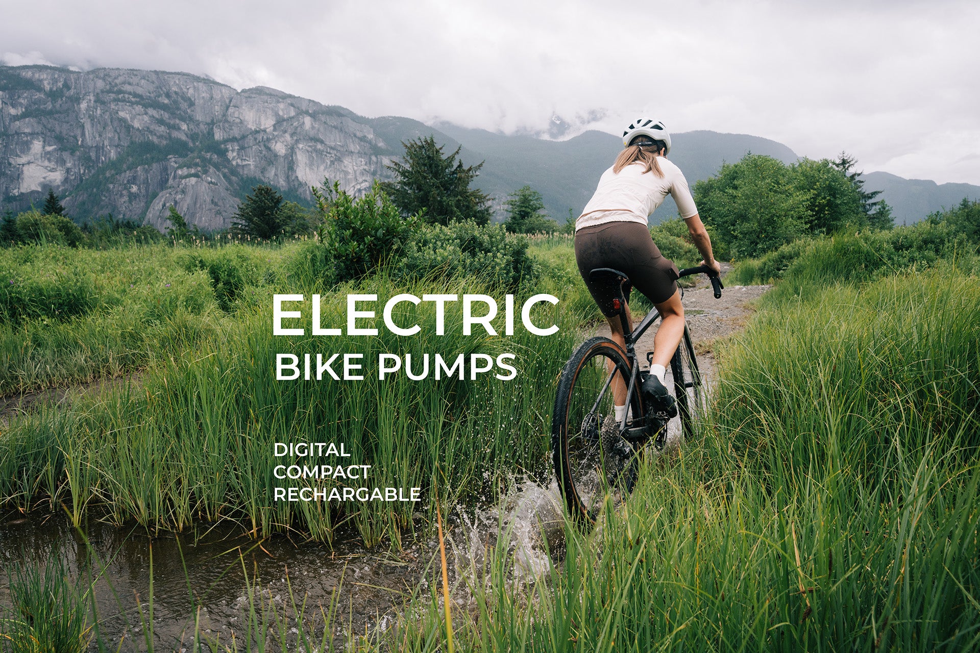 Cyclist riding through wet gravel trail with AYR Cycling logo and tagline promoting compact electric bike pumps.