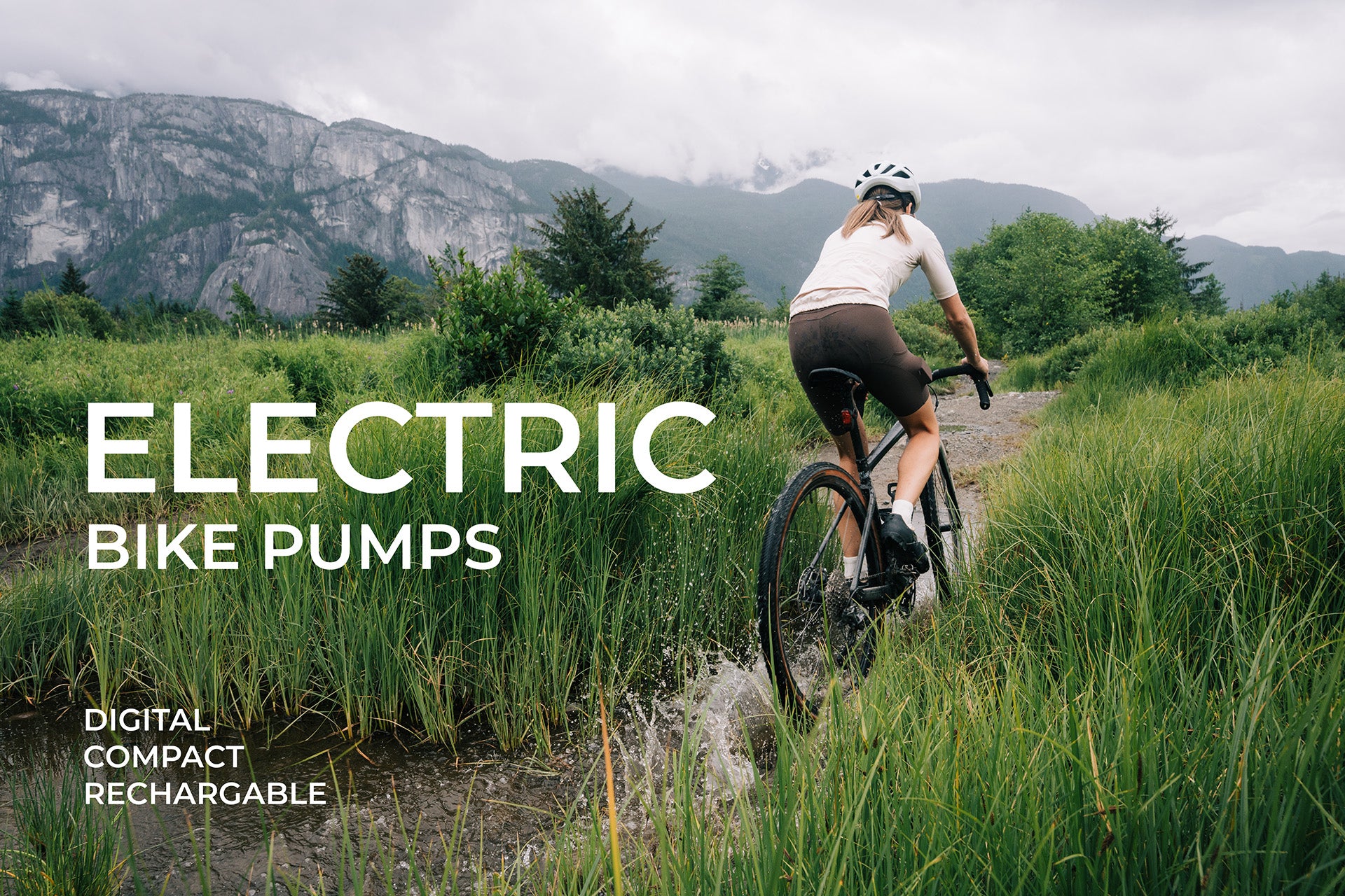 Cyclist riding through wet gravel trail with AYR Cycling logo and tagline promoting compact electric bike pumps.