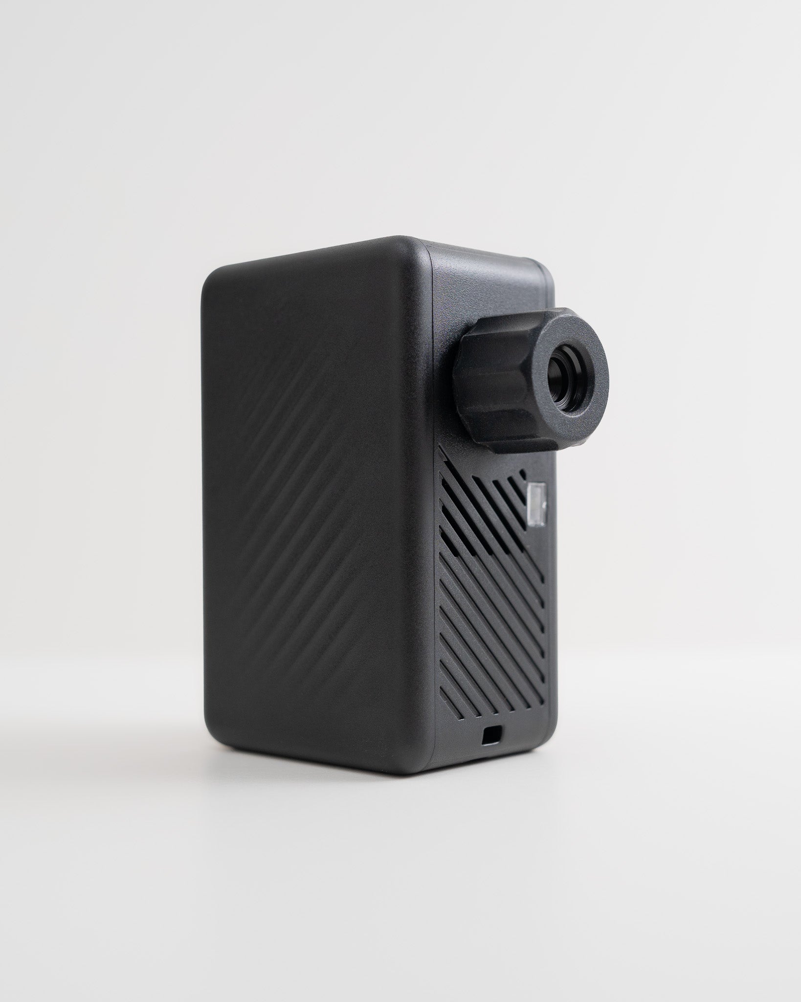 Rear angled view of the AYR Cycling E-Pump showing textured housing and USB-C charging port